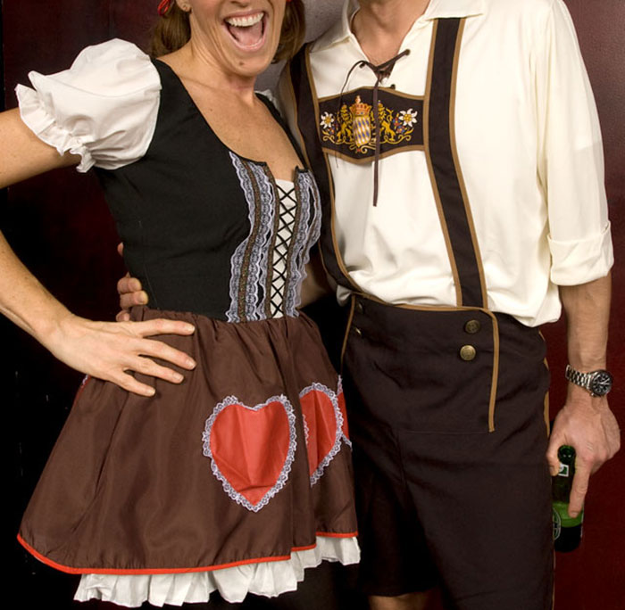 Two people wearing traditional German clothing, representing stereotypes about people’s home countries humorously.