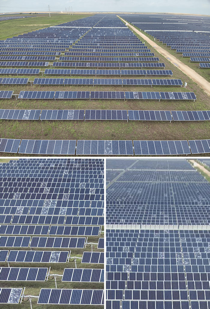 A vast solar panel farm stretching across green fields under a cloudy sky, showcasing renewable energy infrastructure.