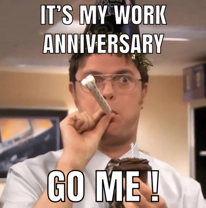 Dwight Schrute from The Office celebrating a work anniversary with a party hat, horn, and cupcake, humorously saying "Go Me!"