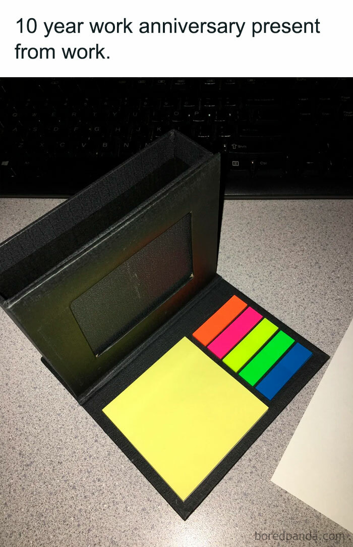 Meme of a modest 10-year work anniversary gift: sticky notes and colorful page markers in a black holder.