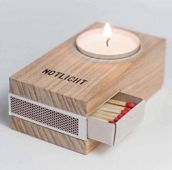 Woodworker crafted wooden matchbox holder with candle on top, showcasing a cool and proud woodworking project.
