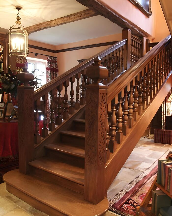 Intricately carved wooden staircase showcasing craftsmanship in woodworking projects inside a cozy, vintage-style home.
