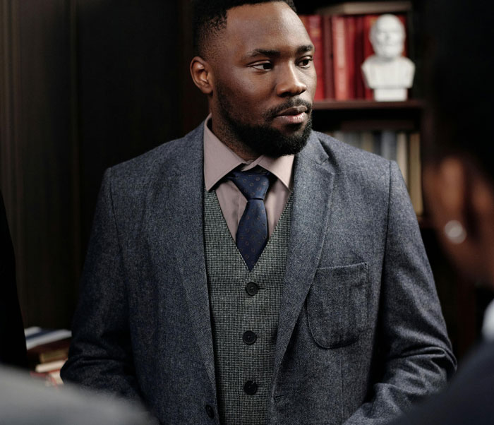 Man in a suit representing jobs once respected but now associated with awful people in a professional setting.