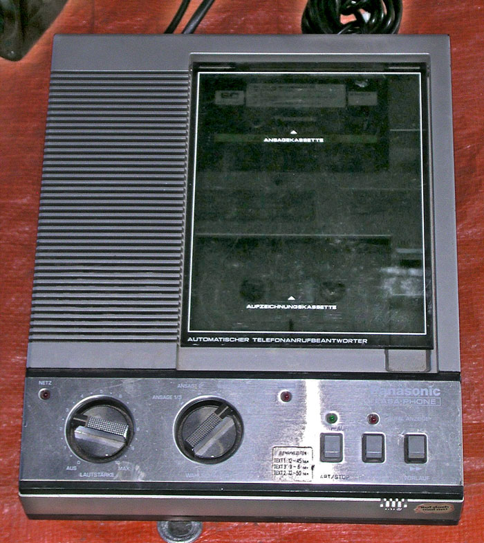 Vintage Panasonic answering machine on wooden surface, related to unhinged and disturbing voicemails received by people.