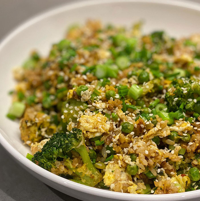 A Lunch idea featuring a bowl of broccoli and egg fried rice, garnished with sesame seeds and green onions, offering a colorful and healthy meal. A Lunch idea featuring a bowl of broccoli and egg fried rice, garnished with sesame seeds and green onions, offering a colorful and healthy meal.
