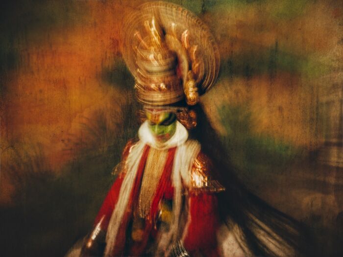Traditional dancer in vibrant costume captured with artistic blur in breathtaking travel photography award-winning image.