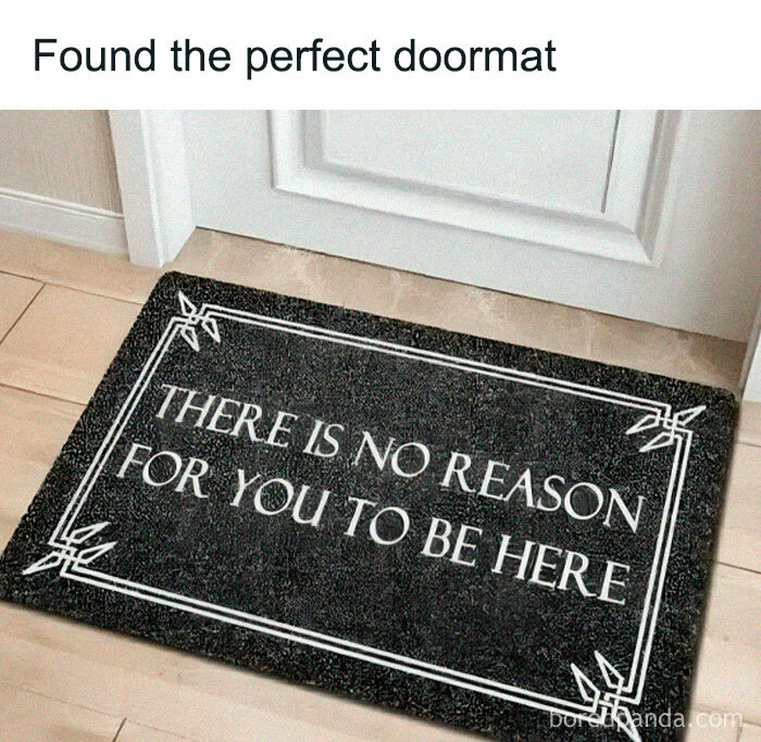Doormat with text "There is no reason for you to be here," humorously unwelcoming.