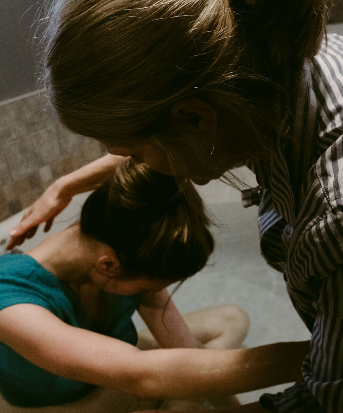 Person comforting another in distress, illustrating a scene related to jobs once respected but done by awful people.