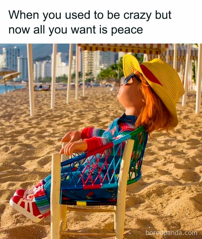 Funny meme with a doll relaxing on a beach chair, wearing a colorful outfit and hat, conveying a peaceful vibe.