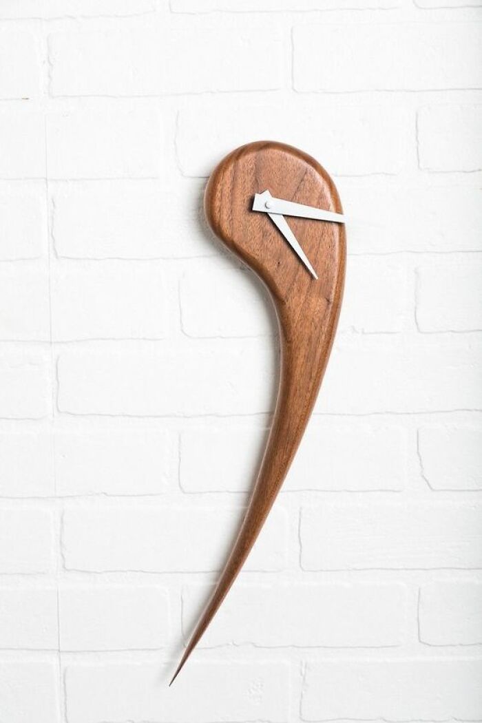 Unique wooden wall clock with an abstract modern design showcasing creative woodworking projects by skilled woodworkers.