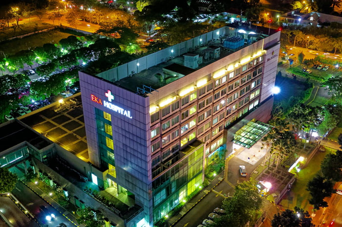 Aerial night view of a hospital building illuminated with lights, representing jobs once respected but done by awful people.