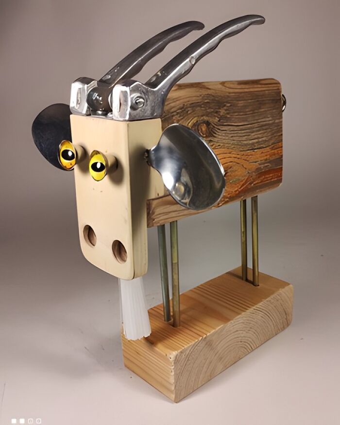 Woodworker's creative animal sculpture made from wood, metal tools, and spoons, showcasing unique handmade project.