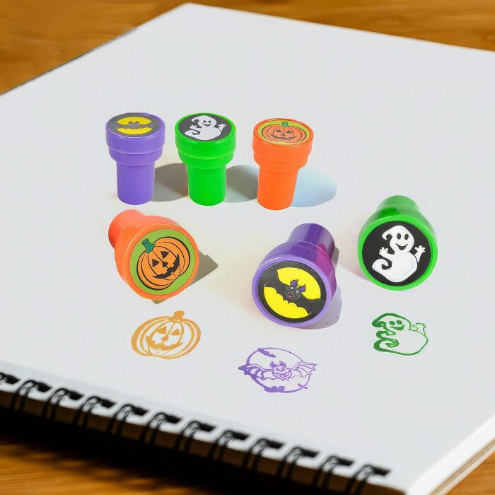Halloween non-candy treat stamps with pumpkin, ghost, and bat designs on a white sketchbook page.