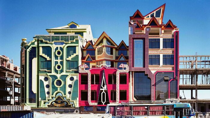 Colorful bizarre buildings with unique geometric designs and shapes, standing out in an urban construction area.
