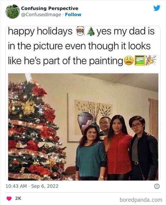 Confusing perspective photo with a family posing near a Christmas tree; one person blends into the background art.