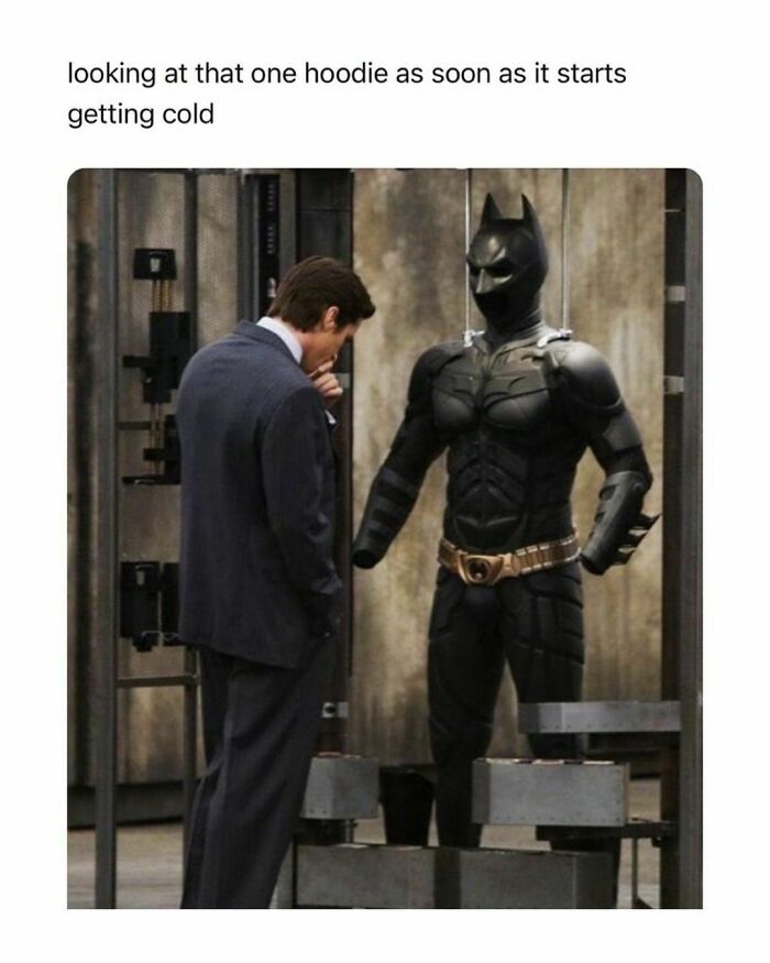 Man in suit looking at Batman suit with text about a hoodie, meme distraction humor.