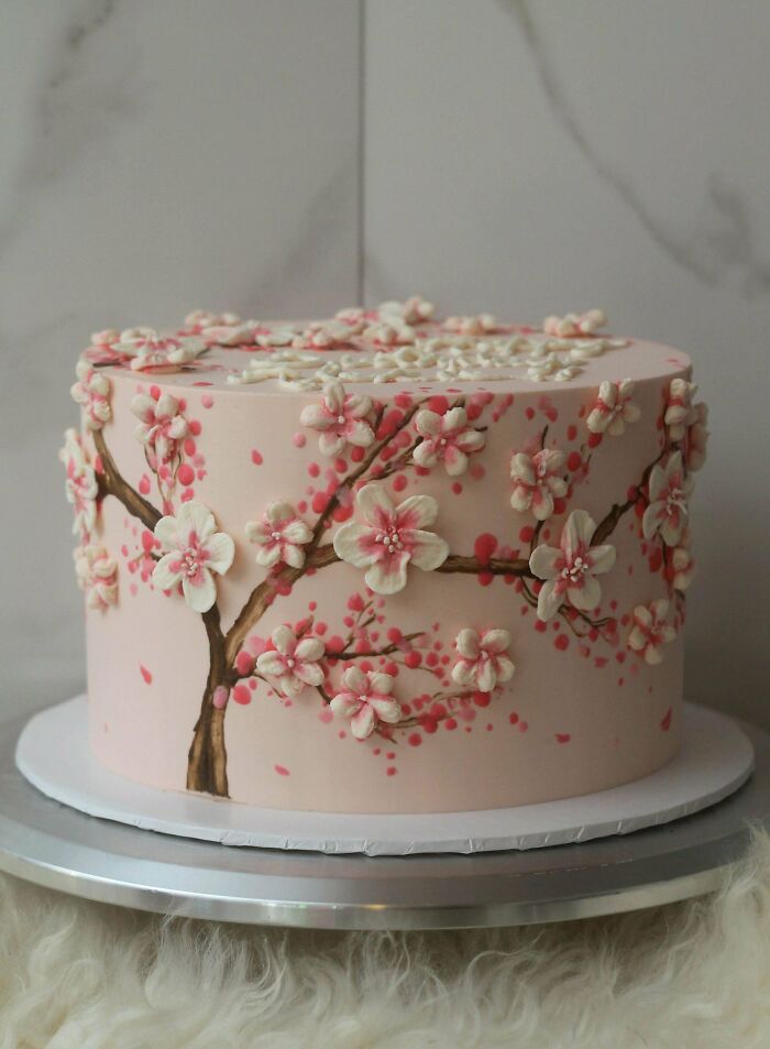 Delicate cherry blossom cake with detailed floral design, showcasing baking at its finest and artistic cake decoration skills.