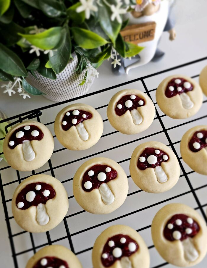 Decorated mushroom-shaped cookies cooling on a wire rack showcasing baking at its finest with creative designs.