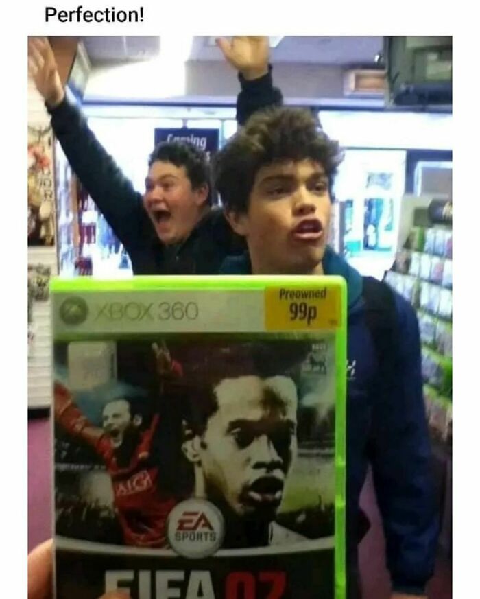 Two excited individuals celebrate holding a budget Xbox 360 FIFA 07 game.