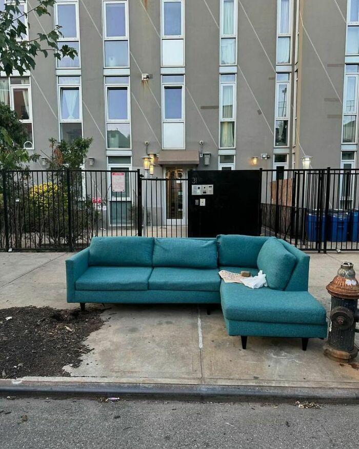 Turquoise sectional sofa left on NYC curb, free for taking, as part of the Stooping tradition.