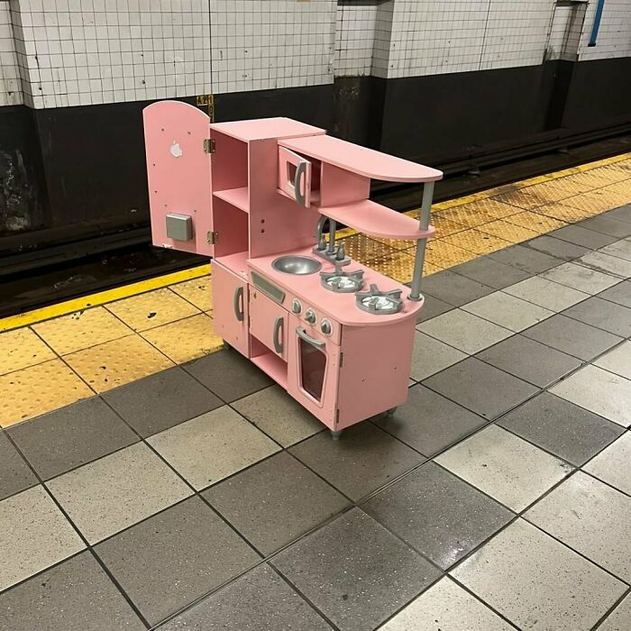Pink toy kitchen left on the curb, part of a 'Stooping NYC' find, waiting for someone to claim.