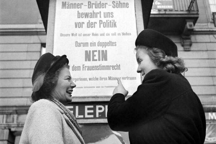 Two Women In Front Of An Anti-Women’s Suffrage Poster In Zürich, Switzerland, 1947