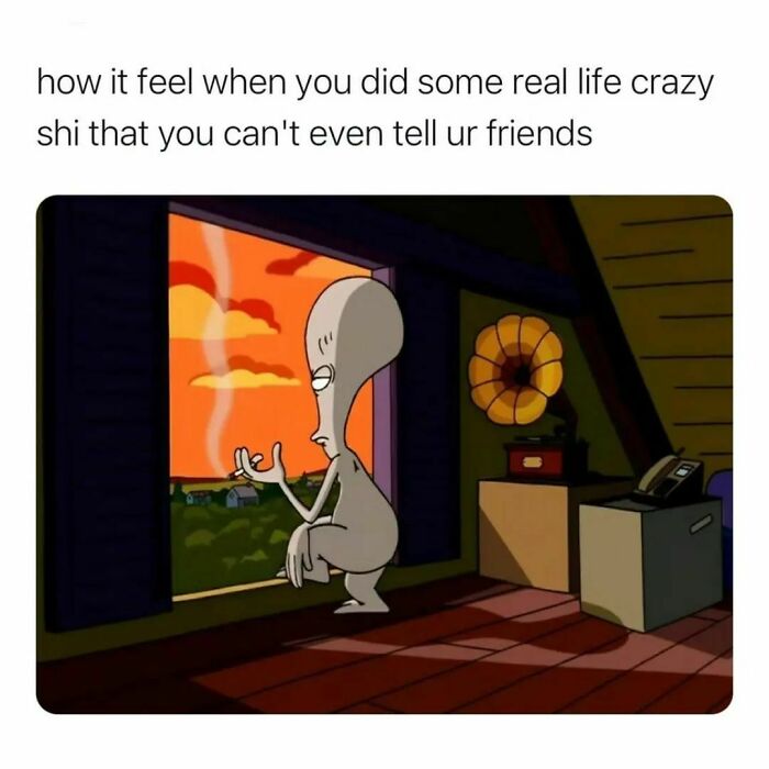 Alien character sitting thoughtfully by a window at sunset, illustrating feelings in hilarious memes to save your day.