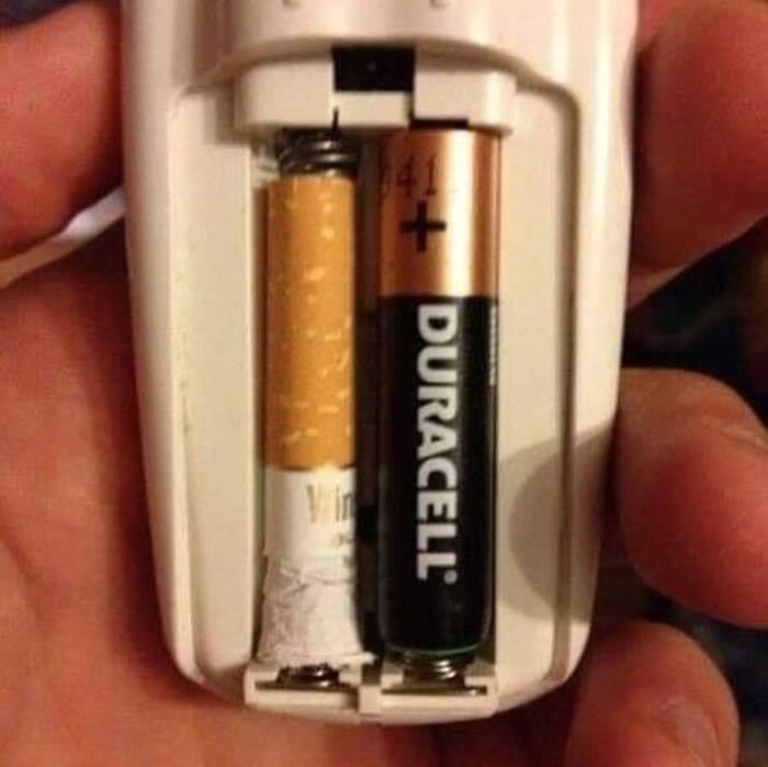 A weird setup with a cigarette and a Duracell battery in a device.