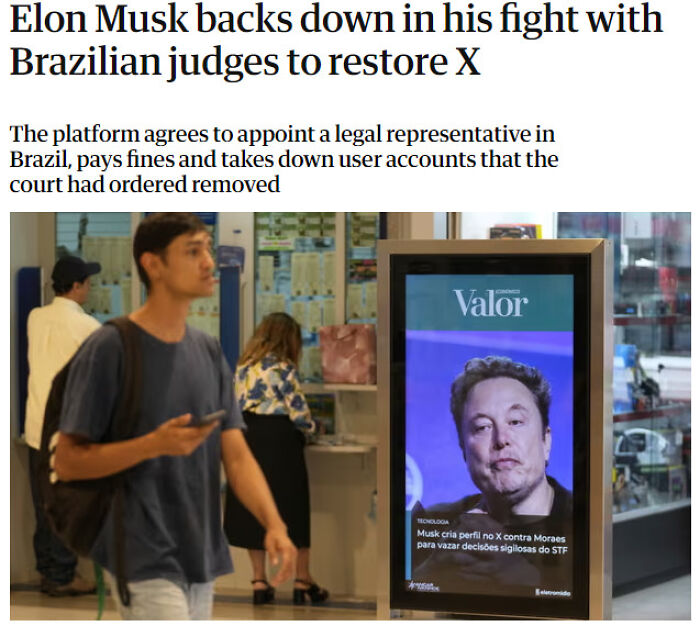 Man walking past a digital news display showing Elon Musk, highlighting facepalm moments of absent basic logic and common sense.