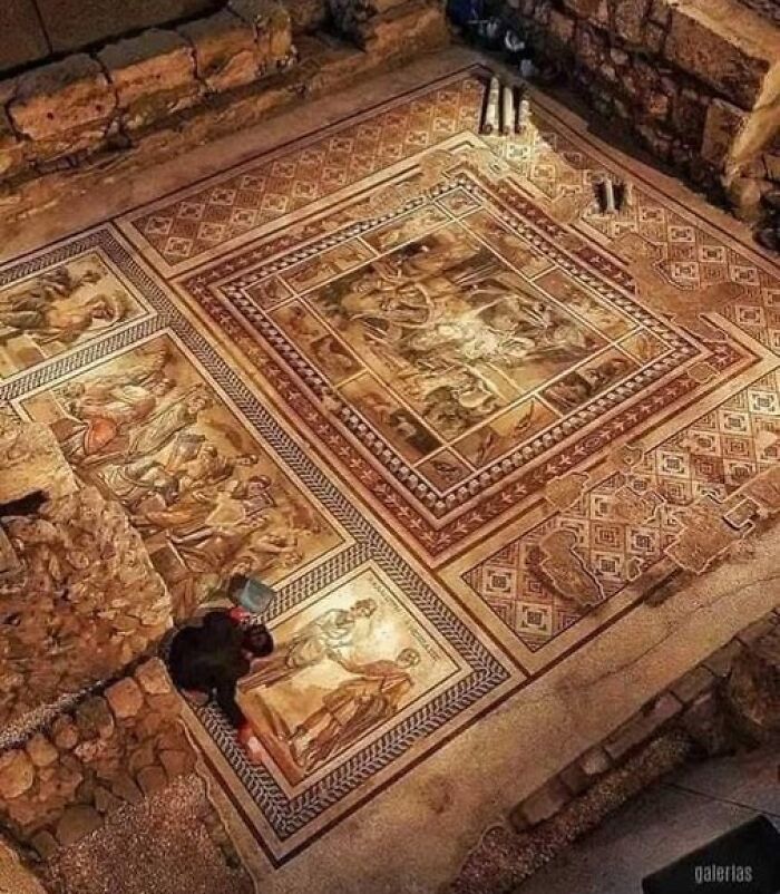 Ancient marvels depicted in a detailed mosaic floor, showcasing intricate designs by an archaeologist in a historic setting.
