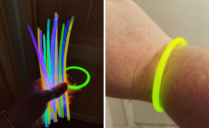 Bright colorful glow sticks held in hand and glowing yellow bracelet worn on wrist as non-candy Halloween treats