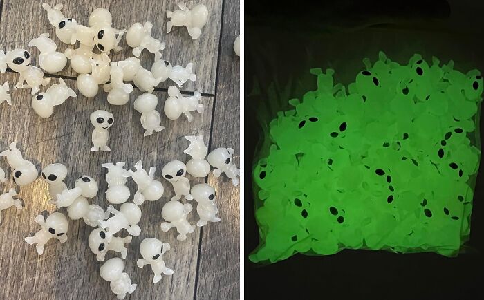 Glow-in-the-dark alien-shaped toys displayed on a wooden surface as a fun non-candy Halloween treat option.