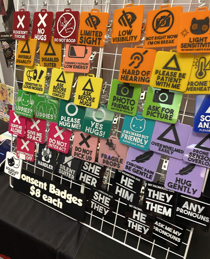 Colorful consent badges on display, each with different messages, priced at $8, showcasing something mildly interesting.