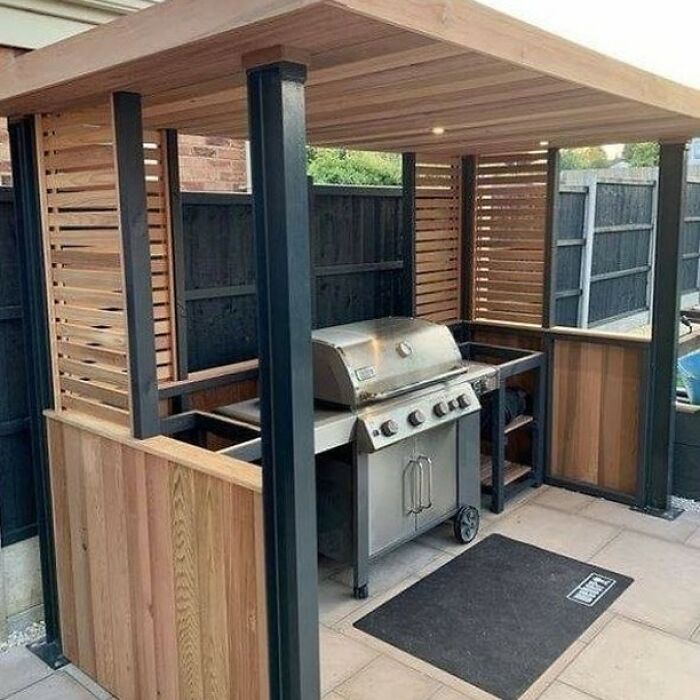 Outdoor kitchen setup with custom woodwork and metal accents showcasing a cool woodworking project by skilled woodworkers.