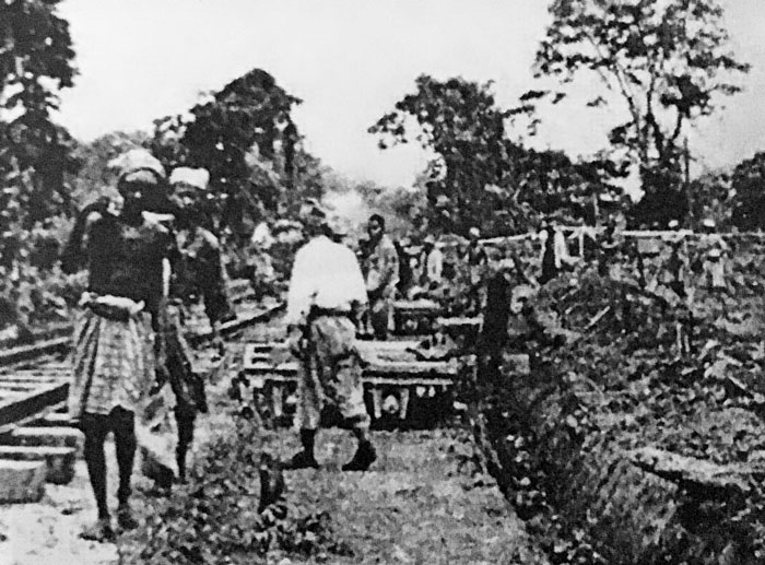 Black and white photo of workers digging by railroad tracks, illustrating chilling truths hidden in plain sight after death.
