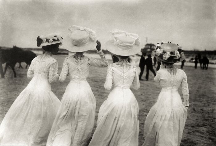 Four women in vintage dresses and hats walking on a beach, showcasing historical and vintage photos from a FB group.