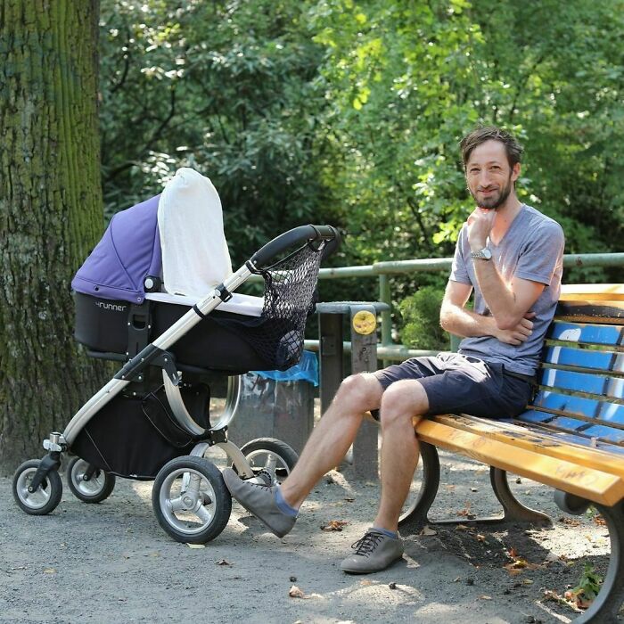 Man sitting on a park bench next to a baby stroller, captured in a moving Humans of New York story.