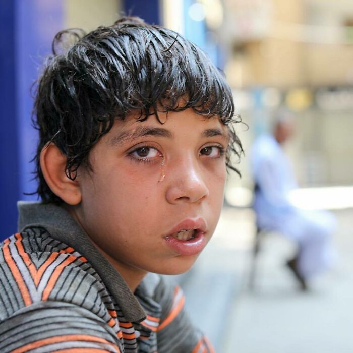 Young boy with tear-streaked face reflecting one of the most moving stories from Humans of New York street portraits.