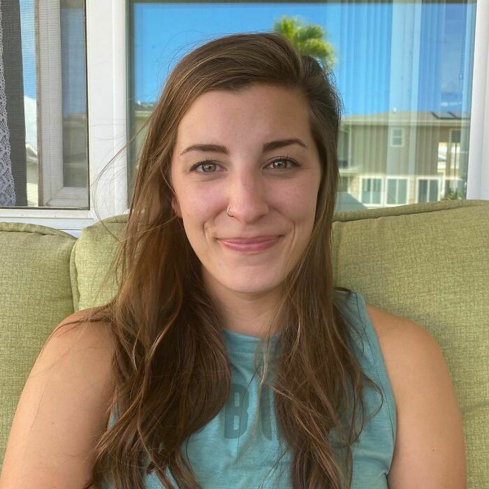 Young woman with long hair smiling on a porch, representing moving stories from Humans of New York series.