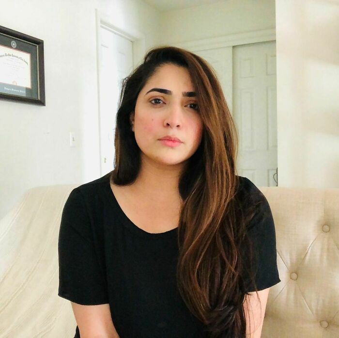 Young woman with long hair sitting indoors, capturing one of the most moving stories from Humans of New York.