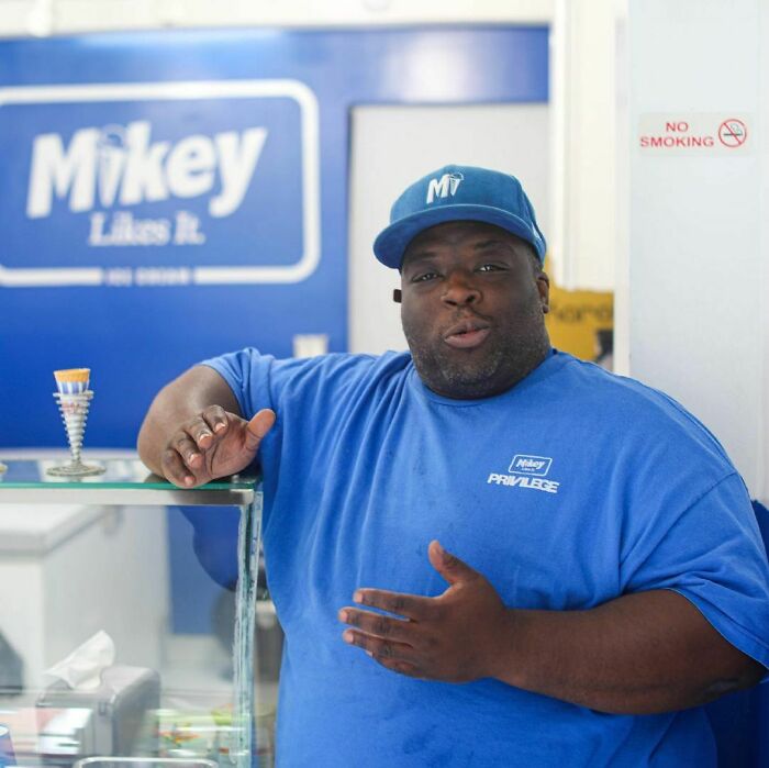 Man in a blue shirt and cap sharing one of the most moving stories from Humans of New York at an ice cream shop.