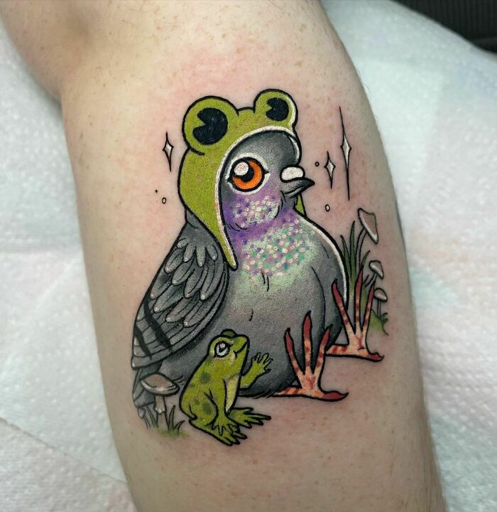 Colorful pigeon with frog on hat and a small frog tattooed on leg, illustrating creative frog tattoos.