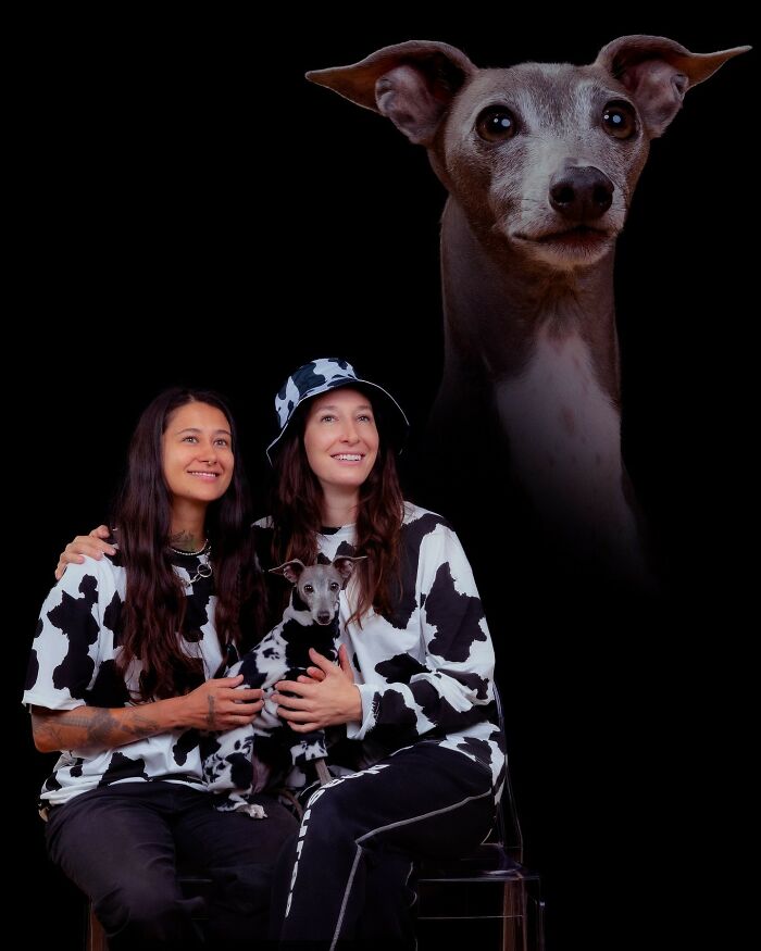 Two women and their dog wearing matching black and white outfits in a quirky portrait captured by a pet photographer.