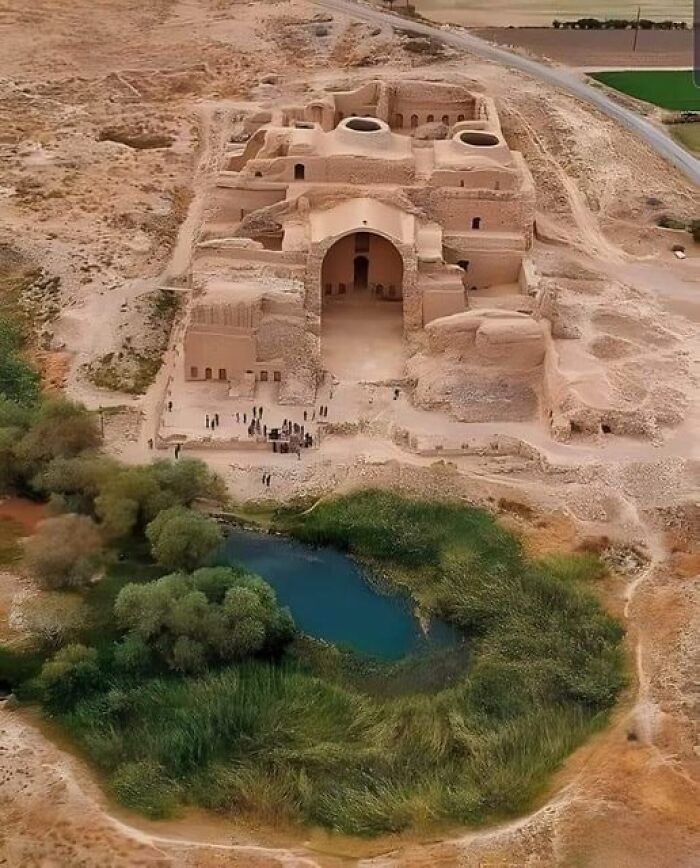 Ancient marvels: Aerial view of a historic structure surrounded by desert and greenery, showcasing architectural brilliance.