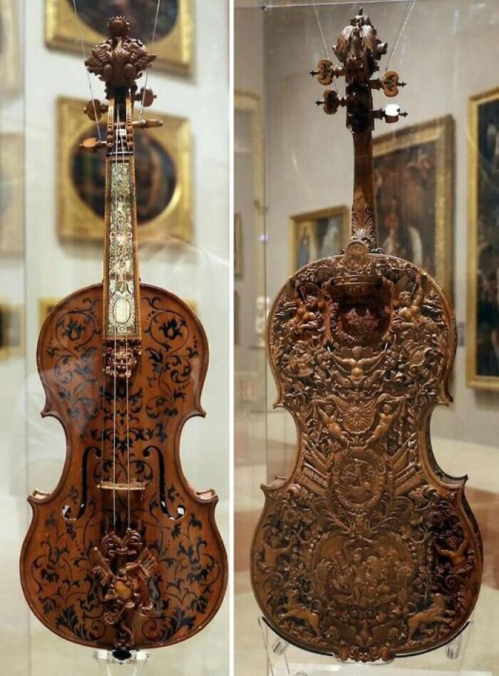 Intricately carved antique violin showcased in a museum, representing ancient marvels of craftsmanship.