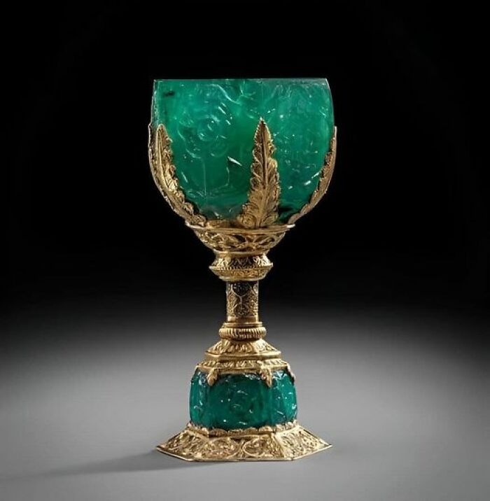 Ancient marvel, an ornate emerald and gold chalice showcasing intricate craftsmanship against a dark background.