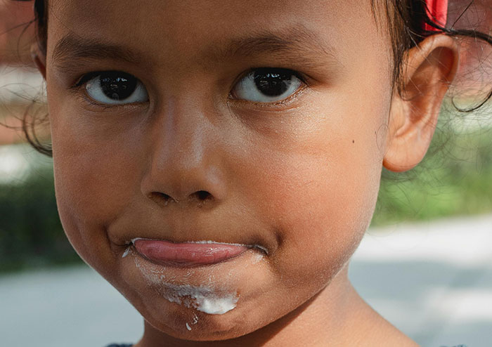 Close-up of a child with food on their face, illustrating encounters with the world’s worst parents and child neglect issues.