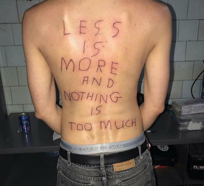 Back tattoo with the words "Less is more and nothing is too much," featured in a Facebook group about tattoos.
