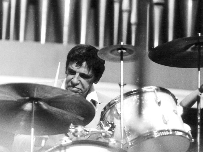 Man playing drums intensely in a vintage black and white photo illustrating iconic last words in history.