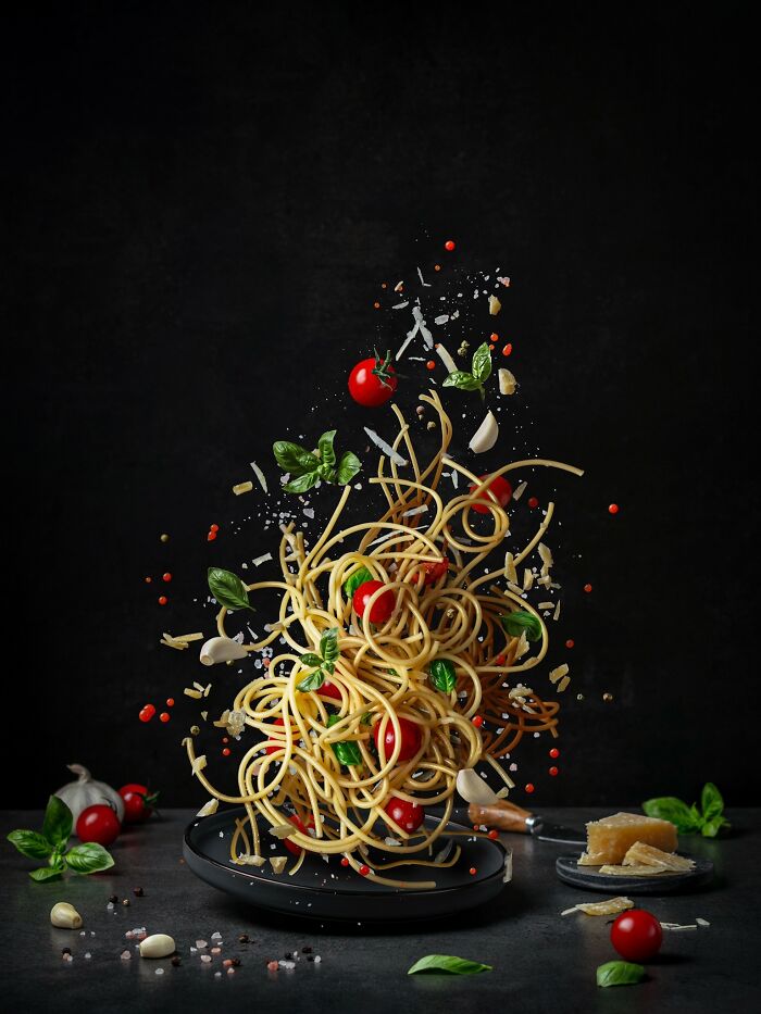 Spaghetti with tomatoes and basil captured mid-air in award-winning Budapest advertising photo 2023.